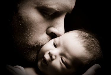 Father Kissing Newborn