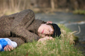 boy_laying_by_river